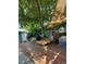 Shaded backyard deck featuring comfortable seating beneath a large tree and sunshade at 4455 Wolff St, Denver, CO 80212