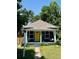 Quaint single-story home featuring a cozy front porch and a distinctive yellow front door at 4455 Wolff St, Denver, CO 80212