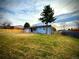 Well-maintained backyard with a mix of green grass and mature trees, offering ample space at 1853 S Urban Way, Lakewood, CO 80228
