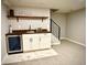 Basement wet bar with open shelf and wine cooler, perfect for entertaining guest at home at 1853 S Urban Way, Lakewood, CO 80228