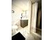 Bathroom featuring a vanity, shower and tub combination, with sleek fixtures and a modern color palette at 1853 S Urban Way, Lakewood, CO 80228