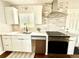 Bright kitchen features stainless steel appliances, tile backsplash, and white cabinets at 1853 S Urban Way, Lakewood, CO 80228