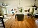 Bright living area with an island and an eating area, hardwood floors, and open layout at 1853 S Urban Way, Lakewood, CO 80228