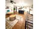 Spacious open living area with hardwood floors, stylish decor, and a view of the modern kitchen at 1853 S Urban Way, Lakewood, CO 80228