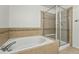 Bathroom with a tub and separate glass-enclosed shower at 5574 W 72Nd Dr, Arvada, CO 80003
