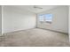 Bright bedroom with neutral carpet, two windows, and a ceiling fan at 5574 W 72Nd Dr, Arvada, CO 80003