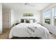Bright bedroom features large window, ceiling fan, and neutral decor at 5574 W 72Nd Dr, Arvada, CO 80003