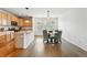 Dining area features a modern table set next to the kitchen with wood cabinets and stainless steel appliances at 5574 W 72Nd Dr, Arvada, CO 80003
