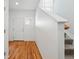 Bright entryway with hardwood floors, stairs, and a view of the front door at 5574 W 72Nd Dr, Arvada, CO 80003