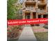 Inviting townhouse featuring a stone facade, covered balconies, and well-maintained landscaping at 5574 W 72Nd Dr, Arvada, CO 80003