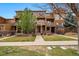 Townhouse complex showcasing multiple units with covered entrances and manicured lawns at 5574 W 72Nd Dr, Arvada, CO 80003