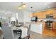 Open kitchen and dining area features stainless steel appliances, wood cabinets and hardwood floors at 5574 W 72Nd Dr, Arvada, CO 80003