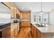 Updated kitchen boasts stainless steel appliances, a sink island, and abundant cabinet space, ideal for cooking at 5574 W 72Nd Dr, Arvada, CO 80003