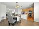 Open kitchen and dining area features stainless steel appliances, wood cabinets and hardwood floors at 5574 W 72Nd Dr, Arvada, CO 80003