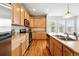 Well-lit kitchen features stainless steel appliances, light wood cabinets, and gorgeous hardwood flooring at 5574 W 72Nd Dr, Arvada, CO 80003