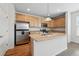 Updated kitchen with stainless steel appliances, an island with a sink, and plenty of cabinet space at 5574 W 72Nd Dr, Arvada, CO 80003