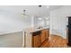 Well-lit kitchen featuring stainless steel appliances and an island with a sink, blending style and function at 5574 W 72Nd Dr, Arvada, CO 80003