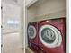 Laundry room featuring a modern red washer and dryer at 5574 W 72Nd Dr, Arvada, CO 80003