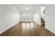 Bright living room featuring hardwood floors, a ceiling fan, and access to the outdoors, perfect for modern living at 5574 W 72Nd Dr, Arvada, CO 80003
