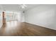 Open living space featuring hardwood floors, large windows, and a ceiling fan at 5574 W 72Nd Dr, Arvada, CO 80003