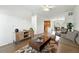 Open floor plan with hardwood floors, and seamlessly connected to a dining area and kitchen for modern living at 5574 W 72Nd Dr, Arvada, CO 80003