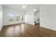 Spacious living area featuring hardwood floors, ample natural light, and stairway access at 5574 W 72Nd Dr, Arvada, CO 80003