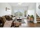 Bright living room features hardwood floors, neutral paint, large windows, and stylish furnishings at 5574 W 72Nd Dr, Arvada, CO 80003