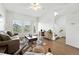 Bright living room featuring hardwood floors, neutral paint, modern furnishings and a staircase to the second floor at 5574 W 72Nd Dr, Arvada, CO 80003