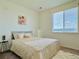 Bright bedroom featuring plush bedding, stylish decor, and a large window with scenic views at 9283 Twenty Mile Rd # 308, Parker, CO 80134