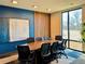 Conference room boasts a large table, comfortable seating, and natural light at 9283 Twenty Mile Rd # 308, Parker, CO 80134
