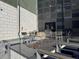 Outdoor grilling area featuring stainless steel grills and comfortable seating around a fire pit at 9283 Twenty Mile Rd # 308, Parker, CO 80134