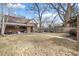 Exterior view of a brick home with a large backyard and covered patio, perfect for outdoor enjoyment at 1905 Niagara St, Denver, CO 80220