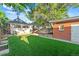 Landscaped backyard features green lawn and a brick garage at 1031 S Pennsylvania St, Denver, CO 80209