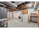 Unfinished basement with laundry, exposed ductwork, and painted brick walls at 1031 S Pennsylvania St, Denver, CO 80209
