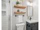 Bathroom with subway tile shower, modern vanity and sink and shelves above the commode at 1031 S Pennsylvania St, Denver, CO 80209