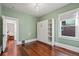 Light-filled bedroom features pale green walls, wood floors, and a built-in Murphy bed at 1031 S Pennsylvania St, Denver, CO 80209