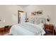 Bedroom boasts neutral colors, a large bed with throw blanket, and bright natural light at 1031 S Pennsylvania St, Denver, CO 80209