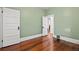 Bedroom features pale green walls, wood floors, and classic white trim at 1031 S Pennsylvania St, Denver, CO 80209