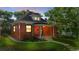 Charming brick home with a covered front porch and well-manicured lawn at 1031 S Pennsylvania St, Denver, CO 80209