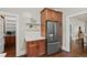 Kitchen area features a stainless steel refrigerator, hardwood flooring, and custom cabinetry at 1031 S Pennsylvania St, Denver, CO 80209