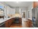 Modern kitchen with stainless steel appliances, white cabinets, and hardwood floors at 1031 S Pennsylvania St, Denver, CO 80209