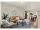 Comfortable living room with decorative windows, stylish furniture, and hardwood floors at 1031 S Pennsylvania St, Denver, CO 80209