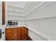 Quaint pantry with built in shelving, tile countertop and vintage cabinetry at 1031 S Pennsylvania St, Denver, CO 80209