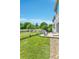 Expansive backyard featuring a well-maintained lawn, white fence, and a patio with outdoor seating at 14944 E Archer Cir, Aurora, CO 80012