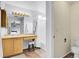 Bright bathroom featuring a vanity with seating and a shower/tub combo at 14944 E Archer Cir, Aurora, CO 80012
