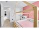 Cozy bedroom with a whimsical canopy bed, complemented by light pink and white decor, creating a dreamy space at 14944 E Archer Cir, Aurora, CO 80012