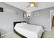 Comfortable bedroom with a ceiling fan, modern decor, and a bed with white linens, creating a cozy retreat at 14944 E Archer Cir, Aurora, CO 80012