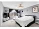 Modern bedroom with large window, gray walls, and an inviting chaise lounge, providing a restful retreat at 14944 E Archer Cir, Aurora, CO 80012
