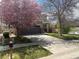 Charming two-story home featuring a two-car garage and a lovely tree in full bloom at 14944 E Archer Cir, Aurora, CO 80012