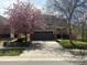 Charming two-story home featuring a two-car garage and a lovely tree in full bloom at 14944 E Archer Cir, Aurora, CO 80012